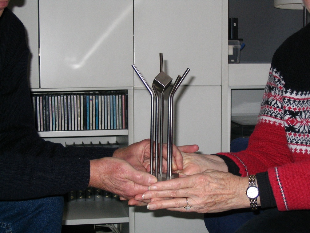 Co de Swart handing Lois Randel a miniature of the memorial for her brother Bob KIA