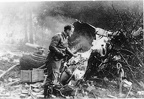 German Fighterpilot looking at the remains of his victim, B-17-3439